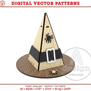 May include: A brown witch hat with a black belt and spider accents. The hat is sitting on a brown surface with a spiderweb design.