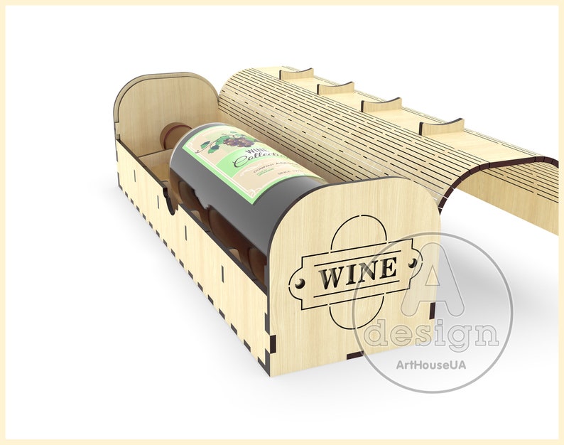 Puede incluir: Una caja de madera para vino con una tapa con bisagras y un hueco para una botella de vino. La caja est&aacute; hecha de madera clara y tiene una etiqueta "WINE" en la parte delantera.