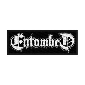 May include: A rectangular black patch with the white text "Entombed" in a gothic font. The text has a textured, dotted pattern. The patch is likely for clothing or accessories, representing a band or brand.