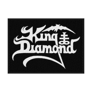May include: A black rectangular patch featuring the white text "King Diamond" in a stylized font. A bat graphic is above the word "King". The patch has a textured surface.