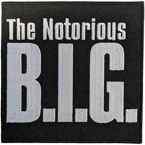 May include: Black square patch with white embroidered text that reads "The Notorious B.I.G." in a bold, blocky font. The letters are thick and stand out against the dark background. The patch has a clean, simple design.