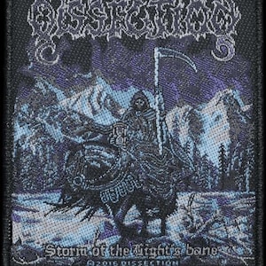 May include: Black embroidered patch featuring the band name "Dissection" in a stylized font. The patch depicts a cloaked figure with a scythe riding a horse in a snowy landscape. Text at the bottom reads "Storm of the Light's bane" and "©2016 DISSECTION".