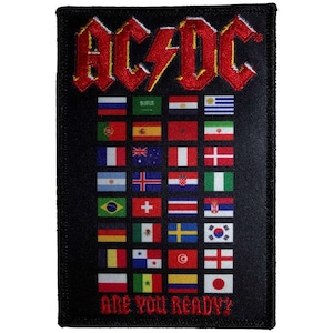 Puede incluir: Parche rectangular negro con el logo de AC/DC en rojo, bordado con un rayo. Debajo del logo, varias banderas de países y el texto "ARE YOU READY?" en rojo.
