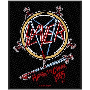 May include: A black and white patch featuring a red, white and blue Slayer logo in a circle with swords around it. The text "Haunting the Chapel 1985" is below the circle. The text "© 2019 Slayer" is at the bottom of the patch.