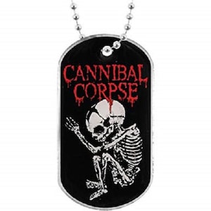 May include: Black dog tag pendant featuring the band name "CANNIBAL CORPSE" in red, dripping lettering. A white skeleton illustration is on the tag. It hangs from a silver ball chain.