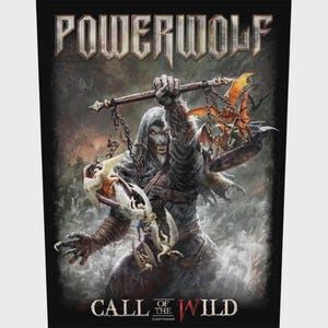 May include: A rectangular graphic print featuring the text POWERWOLF at the top and CALL OF THE WILD at the bottom. The central image depicts a hooded werewolf holding a balance scale with winged figures on one side and a dragon on the other.