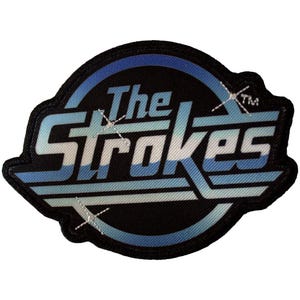 May include: Embroidered patch with the band name "The Strokes". The patch features a black border, with the band's name in a stylized font, and a blue and white colour scheme. The patch is designed for application on clothing or accessories.