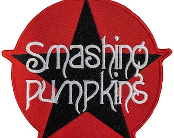 May include: A red, star-shaped patch with a black star in the center. The words "Smashing Pumpkins" are embroidered in white, stylized lettering. The patch has a textured appearance.