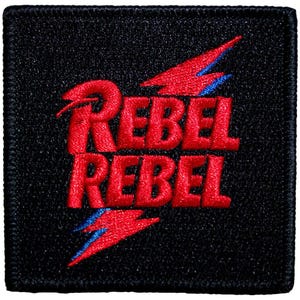 Puede incluir: Parche bordado cuadrado con las palabras "REBEL REBEL" en rojo. El parche negro tiene diseños de rayos rojos con detalles azules. Este parche está diseñado para coser en ropa o accesorios.