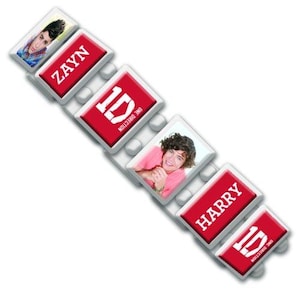 May include: A bracelet featuring images of Zayn and Harry, along with the One Direction logo. The bracelet has red and white rectangular charms with the names and logo printed on them. The bracelet is on a white background.