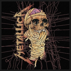 May include: Black and red embroidered patch with the word "Metallica" in a stylized font. A skull wrapped in bandages is in the center of the patch.
