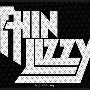 May include: A black patch featuring the band name "Thin Lizzy" in bold, white, stylized lettering. The text is set against a textured black background. The copyright notice "© 2013 Thin Lizzy" is at the bottom.