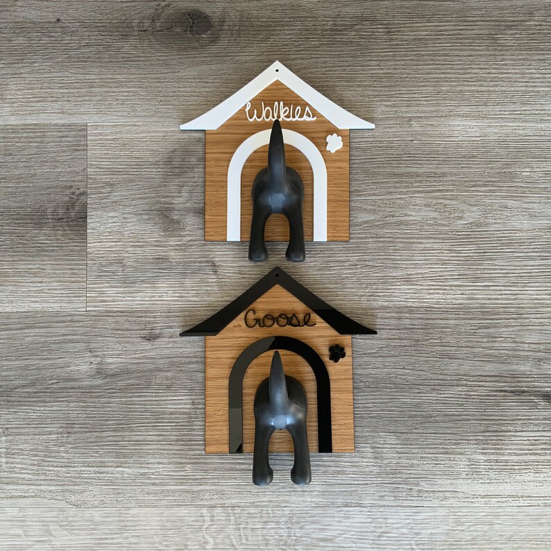 May include: Two wooden dog house shaped hooks with black dog silhouettes. The top hook says "Walkies" and the bottom hook says "Goose".
