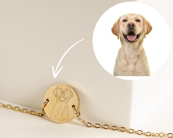 May include: A gold chain necklace with a round pendant featuring a personalized engraved image of a dog.