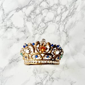 Antique French crown for religious statues made in embossed golden metal adorned with several glass Rhine stones imitating precious stones