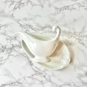 Antique large sauce boat and its white ironstone tray with raised molded decoration
