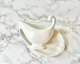Antique large sauce boat and its white ironstone tray with raised molded decoration