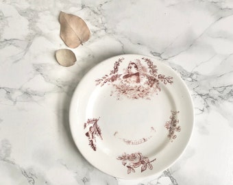 Small antique porcelain plate with burgundy print decor of flowers and a portrait of Queen Victoria R H P & Co