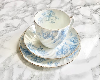 Antique tea trio in white china with blue flowers