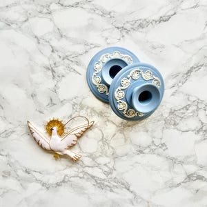 Pair of round baby blue jasper ware candlesticks with raise decoration of white antique pattern Wedgwood