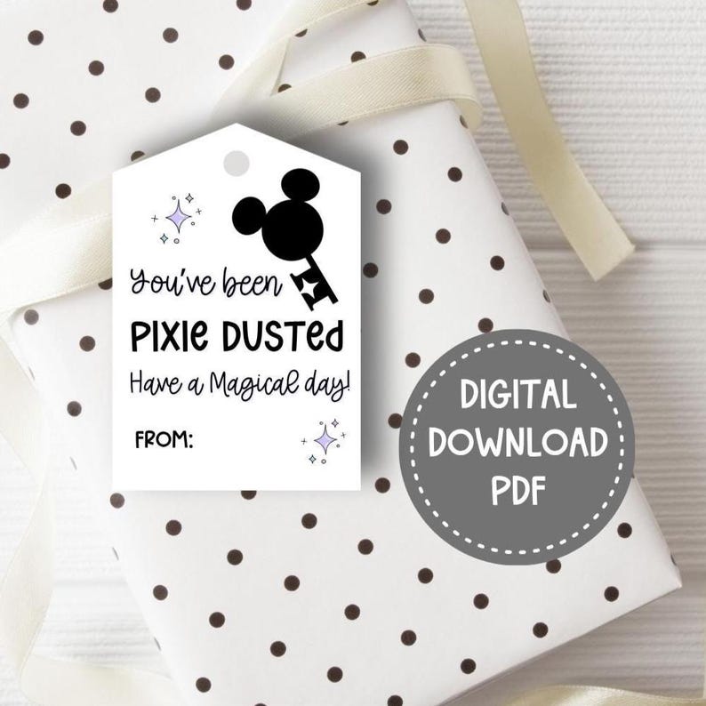 May include: A white rectangular gift tag with a hole at the top, featuring a black silhouette of a mouse-ear key, purple star icons, and the black text: You've been PIXIE DUSTED Have a Magical day! FROM: A gray circular badge reads DIGITAL DOWNLOAD PDF.
