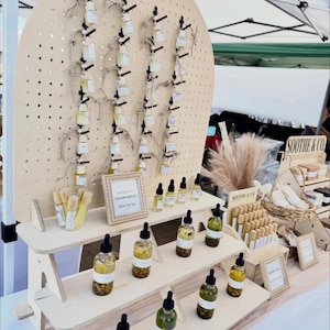 Collapsible three-tiered shelf with pegboard backer image 1