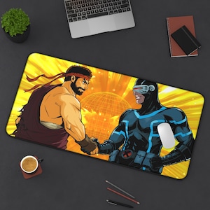 May include: A yellow and orange gaming mouse pad with a graphic of two characters facing each other. One character is wearing a red headband and a blue and brown outfit. The other character is wearing a blue and black suit with a visor.