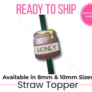 May include: A straw topper featuring a honey pot design with the word "HONEY" on the front. The topper is brown with yellow accents and is attached to a green straw. Text on the image says "READY TO SHIP" and "Custom Colors Available."