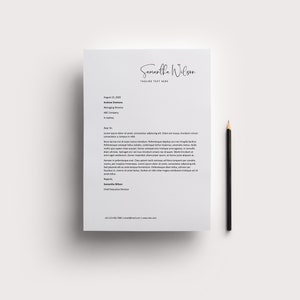 May include: A white letterhead with the name "Samantha Wilson" in elegant script, along with the tagline "TAGLINE TEXT HERE." The letter includes a date, recipient details, and body text. A black pencil rests beside the letter.