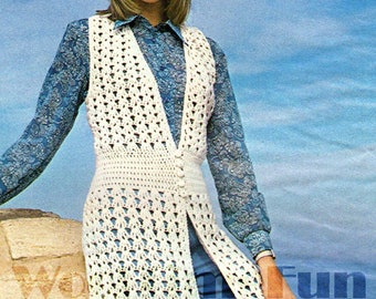 May include: A white crochet vest with a button closure and a long, open front. The vest is worn over a blue patterned shirt and blue pants.
