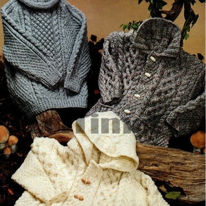 May include: Three hand-knitted sweaters in the image. A gray turtleneck sweater, a gray and brown collared sweater with wooden buttons, and a cream-colored hooded sweater with wooden toggles. All sweaters feature cable knit patterns.