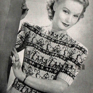 May include: A black and white patterned sweater with a crew neck and short sleeves. The sweater features a repeating design of houses and trees.