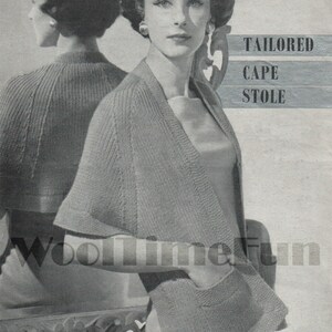 May include: A black and white photo of a woman wearing a knitted cape and stole. The cape has a pocket on the front. The text "Tailored Cape Stole" is printed on the image.