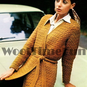 May include: A long, brown crocheted cardigan with a belt. The cardigan has a V-neck and long sleeves.