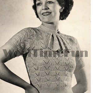 May include: A vintage knitting pattern for a women's sweater with a delicate lace design. The pattern features a close-up of the sweater's neckline and a detailed description of the stitches.