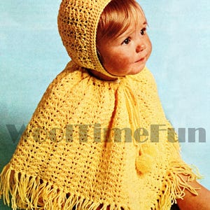 May include: A yellow crocheted poncho and matching hat with fringe trim and pom-poms. The poncho has a tie closure at the neck.
