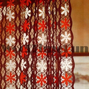 May include: A crocheted curtain with a brown background and white and red flower designs.
