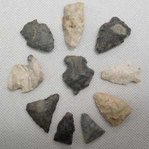 May include: A set of three ceramic mugs with a speckled, matte finish. The mugs are in shades of cream, light gray, and dark gray. Each mug has a simple, minimalist design, perfect for coffee or tea.