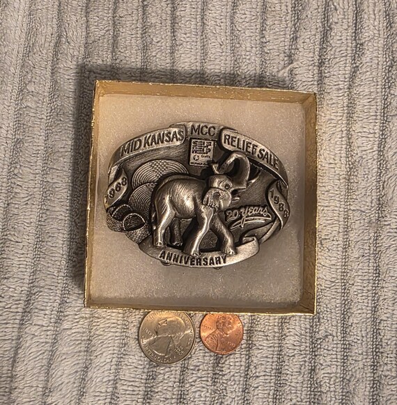 Vintage 1988 Metal Belt Buckle, Mid Kansas Relief Sale, Elephant, Sits on Stand in Back View 2