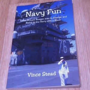 May include: A book titled "Navy Fun" with a navy ship and a sailor in uniform on the cover. The text reads "When Ronald Reagan was in Charge, and Being in the Navy was a Blast" and "Vince Stead". The cover is blue.
