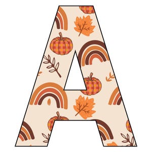 May include: A large, white letter A with a fall-themed pattern. The pattern includes orange pumpkins, brown rainbows, and orange leaves.