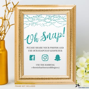 May include: A teal and white printable sign with the text "Oh Snap!" and instructions to share photos using a Snapchat geofilter and hashtag #themichaelsonwedding2017. The sign is framed in gold.