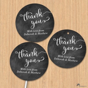 May include: Three round black and white thank you tags with the text "thank you" in a white cursive font. The text "With love from Deborah & Matthew" is printed below the cursive text.