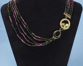 Multi-wire necklace of faceted polychrome tourmaline, with worked gold closure. Piece