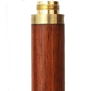 May include: A wooden and brass needle case with a lid. The case is made of dark wood with a natural grain pattern. The lid is made of brass with a gold finish.