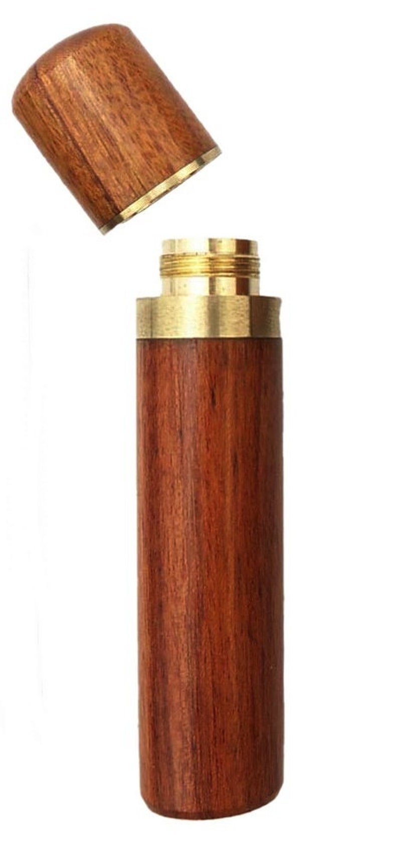 May include: A wooden and brass needle case with a lid. The case is made of dark wood with a natural grain pattern. The lid is made of brass with a gold finish.