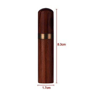 May include: A wooden needle case with a brass band around the middle. The case is 8.3 inches tall and 1.7 inches wide.