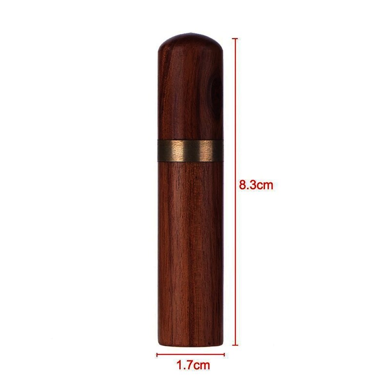 May include: A wooden needle case with a brass band around the middle. The case is 8.3 inches tall and 1.7 inches wide.