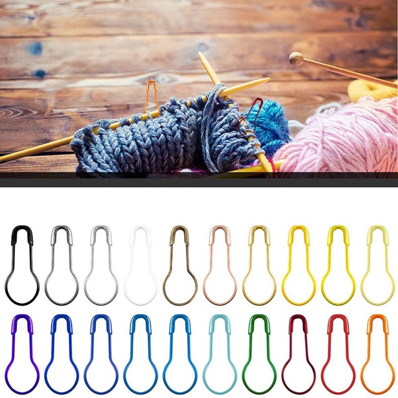 May include: Assortment of 20 safety pins in various colors, including black, silver, white, gold, rose gold, yellow, red, blue, light blue, and turquoise. The pins are arranged in two rows of ten.