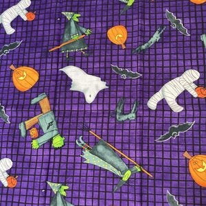 May include: A purple fabric featuring a black grid pattern and a repeating Halloween print. The design includes orange pumpkins, white mummies, green-skinned witches on broomsticks, white ghosts, black bats, and green-skinned monsters.